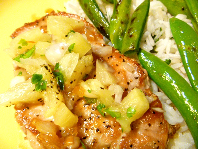 A light and tropical flavored dish of Pineapple Pork Chops with Snap Peas and Jasmine Rice. Perfect for a summer weeknight meal. - Slice of Southern