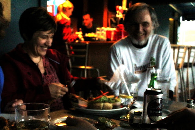 Alto, Jo, and tenor, David, relax at season's end pub night.