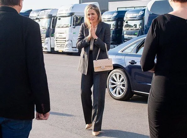 Queen Maxima wore Massimo Dutti herringbone blazer and trousers, suit. Gianvito Rossi pumps, carries Chanel bag