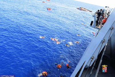 Heart-wrenching photos of migrants being flipped into the sea as their overcrowded boat overturns off the coast of Libya