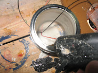 Applying hot glue on the lid of the jar