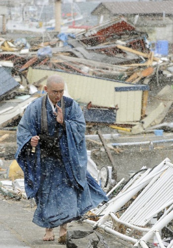 Buddhist monk among the rubble in Yamada, Japan