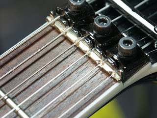 7-string locking nut compensation