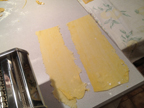Thinly rolled sheets of pasta, top and bottom layers, ready for ravioli filling