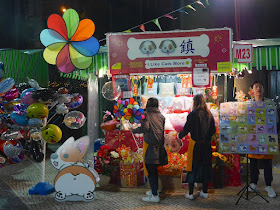 stall selling dog-themed items with the slogan "I Like Cats More"