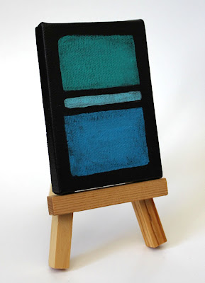 blue and green color field painting on an easel