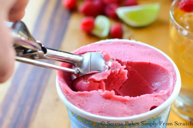 Raspberry Sorbet being scooped with a small scooper.