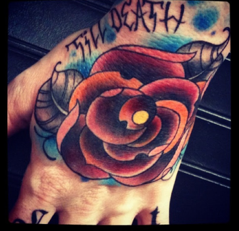 Traditional rose tattoo Hand tattoo title=