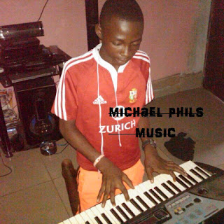 Young nigerian boy playing and practicing the piano