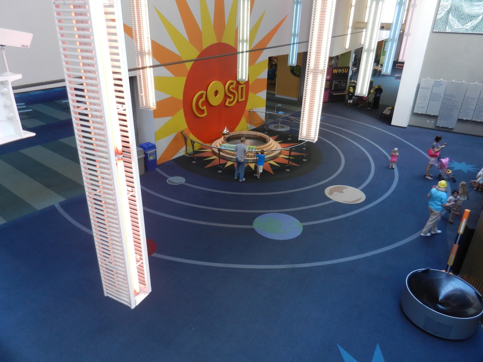 beauty of everyday life COSI stuck on the unicycle over the lobby