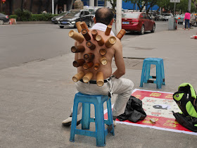 back of man receiving cupping therapy using bamboo cups