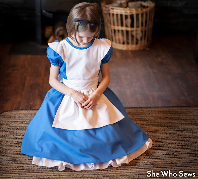 Petticoats showing under skirt Apron spread over blue dress skirt