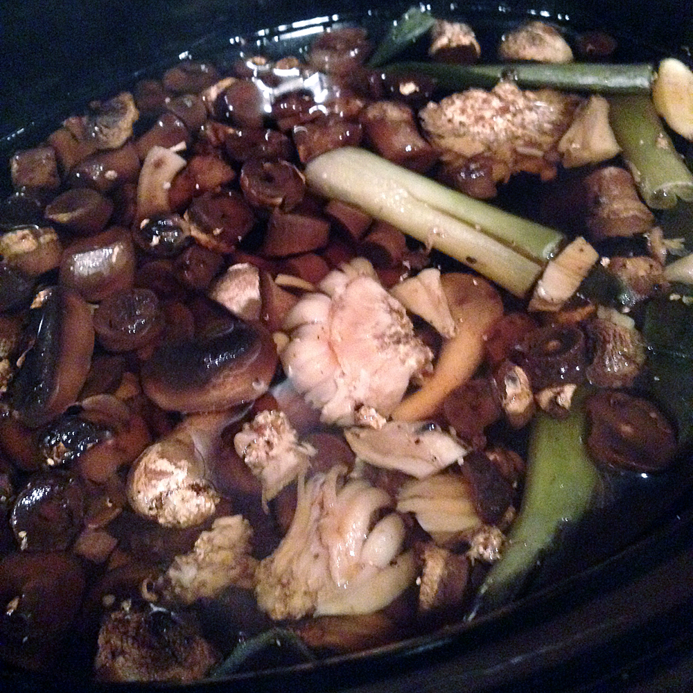 Basic mushroom stock simmering in a slow cooker.