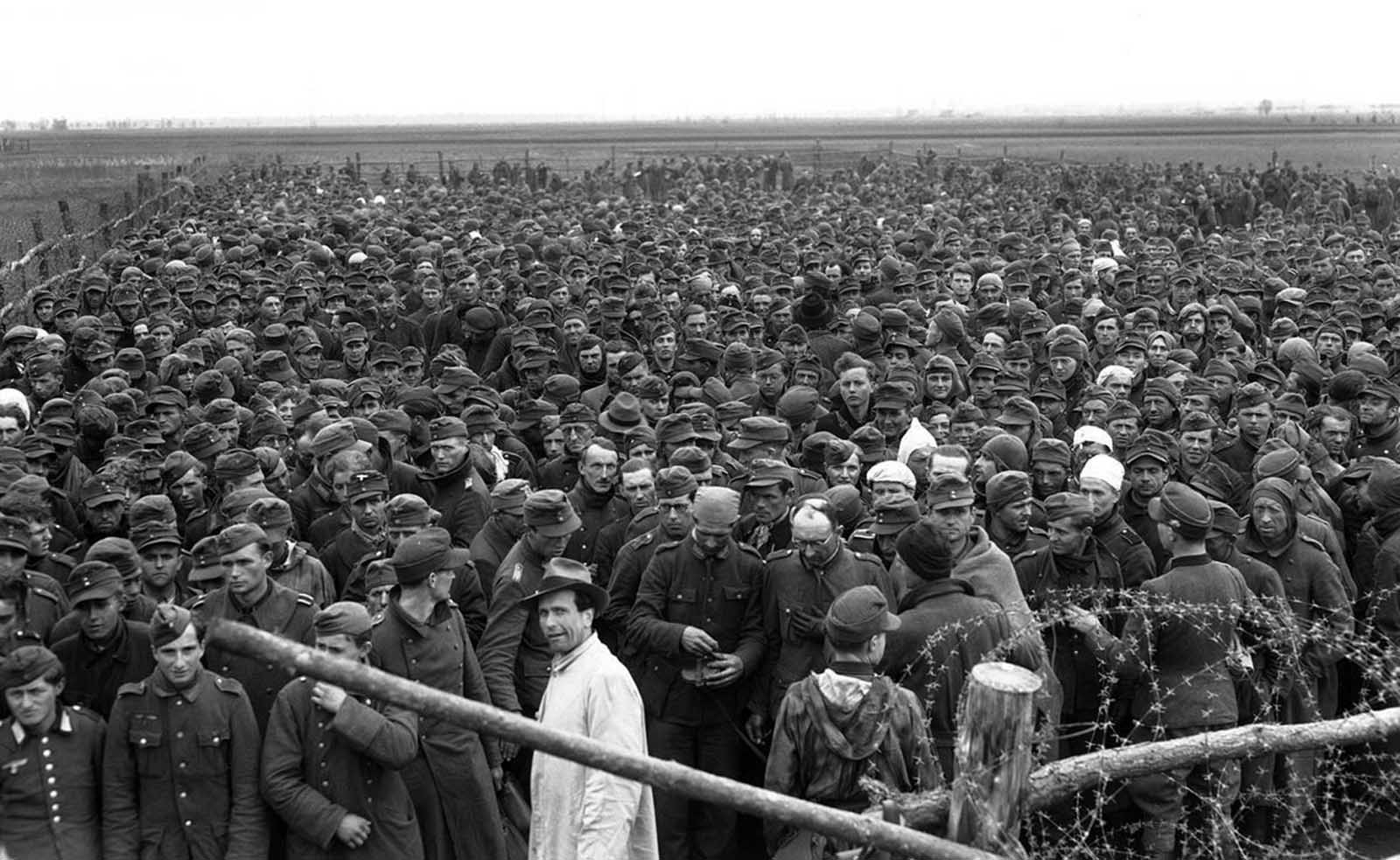 Compounds erected by the Allies for their collections of prisoners never seem to be big enough, here is an over-crowded cage of Germans rounded up by the Seventh Army during its drive to Heidelberg, on April 4, 1945.