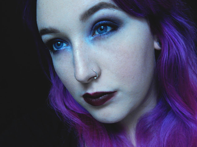 Dark eye makeup and lipstick on a girl with purple/pink hair