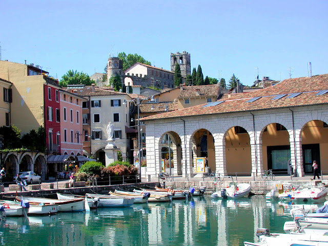 The old port of Desenzano on Lake Garda in Italy with its medieval castle guarding over the village below.