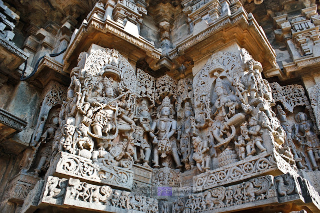 Wall sculptures with drum dancer at the center, here the ropes of the dhol or dholi is carved out of the stone leaving behind hollow sections inside, giving a view of a real Dhol or Hand Drum