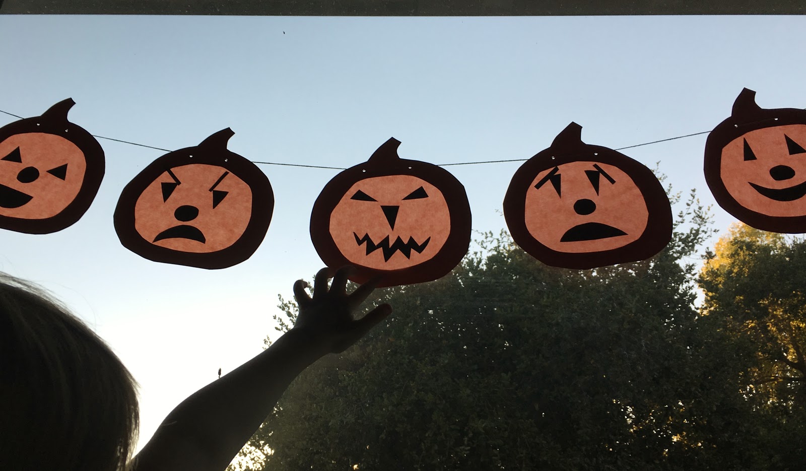 we bloom here jackolantern window garland
