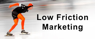 What does marketing mean to your organization? Is marketing an operational expense or a profit center? The difference is not academic. Ice skater in orange and black quickly moving right with the text "low friction marketing" on black letters on the right