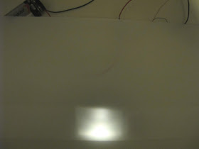 Light shining behind a white plastic folder.