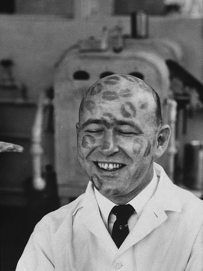 60 Inspiring Historic Pictures That Will Make You Laugh And Cry - Worker In Cosmetic Company Covered With Relics Of Lipstick Kisses To Prove That Dyes In Lipsticks Are Harmless, 1960