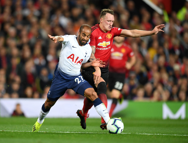 Lucas Moura of Tottenham Hotspur is tackled by Phil Jones of Manchester United during the Premier League match between Manchester United and Tottenham Hotspur at Old Trafford on August 27, 2018 in Manchester, United Kingdom.