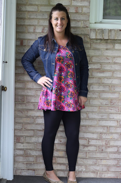 denim jacket with graphic tunic and black leggings