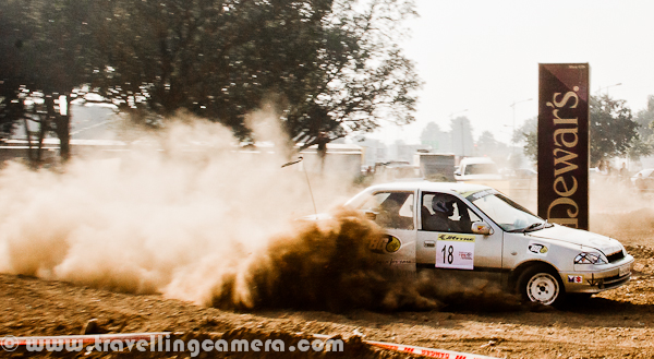 Last week, a motorsport event took place in Mohali (Near Chandigarh), which was organized by OYA Auto Cross and Motorcross. JK Tyre was one of the main sponsor of this event and it continued for three days. During final day I also visited the ground to bring this PHOTO JOURNEY for you. Let's check it out...Cars were literally flying on this ground and whole region was full of dust only. At times it was difficult to see these moving cars. It was hard to imagine that we were standing on a ground which is not in states like Rajasthan. The only word was coming to my mind at that point of time - Dust-Storm, like the one happens in Rajasthan; 'Desert Storm'... Let's check out more photographs from this series of Dust-Storm in Chandigarh...Different types of Cars and Bikes participated in this event, but cars competitions were mainly compelling us to rename it as 'Dust Storm'. Only two cars at a time were enough to cover sky with dust.I am not sure what this 'Dewars' was, but various pillars were planted on this ground. These should be some brands who supported this motorsport event. Barista was also there to serve snacks and drinks, but not sure if they were sponsors or not.Different cars by Honda, Maruti, Mitsubishi & Toyota participated in this event. At times, it was hard to believe that some specific cars can fly like this... One of the rider was very well controlling a white Swift, and it was competing with a 4 by 4 Jypsy...These cars were making the ground-dust to fly in air and at times, they used to cover themselves by dust storms. Specifically, there was huge dust on taking any turn.A colorful Maruti Car going down into a tunnel which was created artificially on this ground for Motorcross competitions during 3rd OYA sports-event.Passion of all these riders was commendable and it was hard to imagine that human beings were driving these super-machines.'Dust Storm' is something coined on run-time and not related to this event.I tried to check about this event on FMSCI website but couldn't find any details. Website of OYA was not much helpful for me to get information as non-motorsport person. Anyway, please have a loo at following link to know more about the organization which organized this event in Mohali - http://oyamohali.comWhole ground was surrounded by lot of people who wanted to see these races, but unfortunately the dust was biggest enemy. After one lap of car racing, there was nothing visible on ground. So everyone was more excited about bike racing, which had more participants at one point of time and things were visible as least.Motrosports in India is one of the increasing passion among people in cities like chadigarh. Now India is also getting some powerful machines, which was not that easy few years back. But still lot of folks can't afford these powerful machines without sponsorship and in such competitions, it's not easy thing to compete with imported machines with our usual bikes.Another shot where another car is contributing to Dust Storm on this ground in Mohali, Punjab, INDIA...After lot of dust in above photographs, I also thought of sharing some bike photographs to show another side of the PHOTO JOURNEY...It seems that bikers in such competitions also use their legs as supporting equipment while turning these machines on extremely high speed.With this, let me finish this Photo Journey of Dust Storm in Chandigarh (Mohali, Punjab)