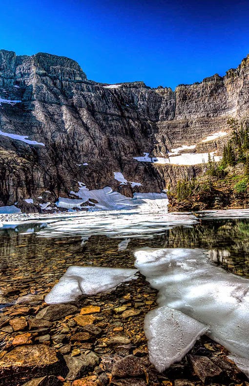 Iceberg Lake is located in Glacier National Park, in the U. S. state of Montana. Mount Wilbur is south and Iceberg Peak is west of Iceberg Lake. Iceberg Peak towers more than 3,000 feet (910 m) above the lake.