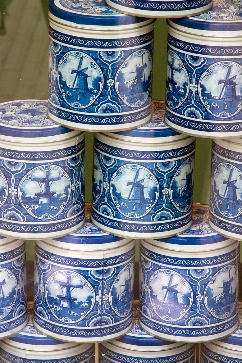 stacked blue cans containing a Dutch delicacy