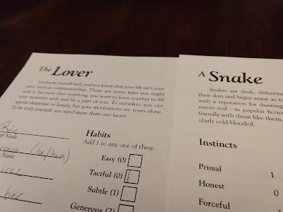 Two character sheets, one labeled The Lover, the other labeled a Snake. 