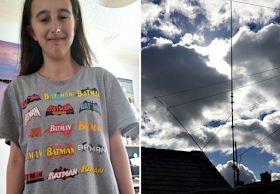 My teenage daughter in a batman t-shirt and the radio antennas against a cloudy sky.