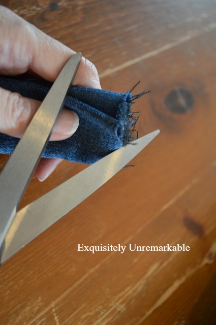 Fraying denim fabric with scissors