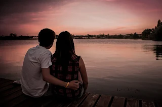 couple cuddling at sunset relationship goals