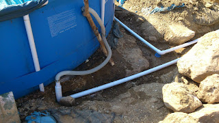 Close-up of the connecting tails that link the new underground pipework to the inlet and outlet on the side of the pool