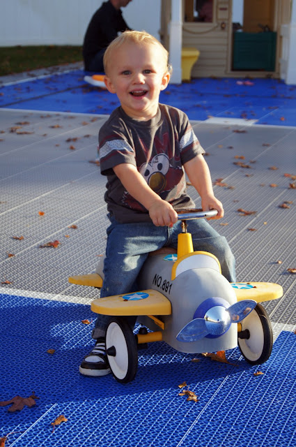 toddler on toy plane