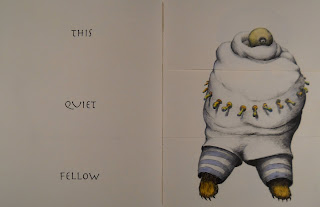 An open book. The lefthand page reads "This Quiet Fellow" and the righthand page shows an illustration of a bulky creature with a small, single-eyed head.