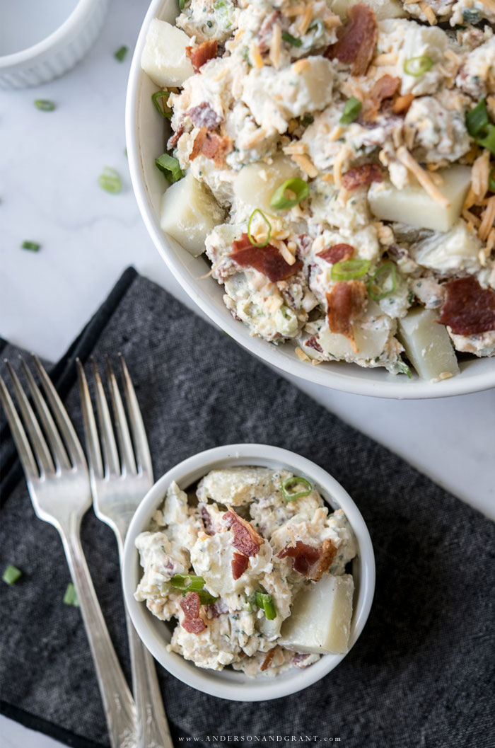 Bowl of potato salad with forks and napkin