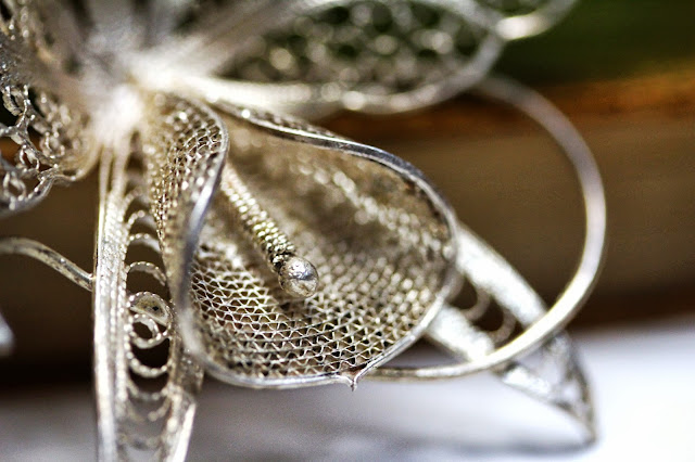 Antique metal lace work on a floral brooch