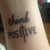 Think positive ink tattoo on wrist