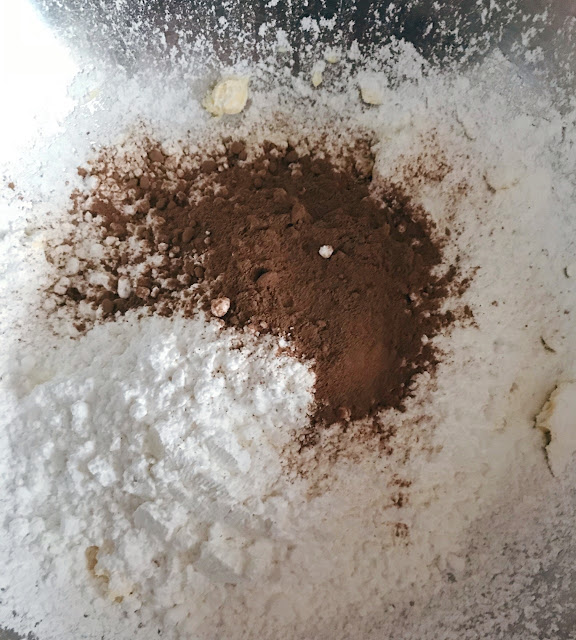 Icing sugar and coco powder sieved in 