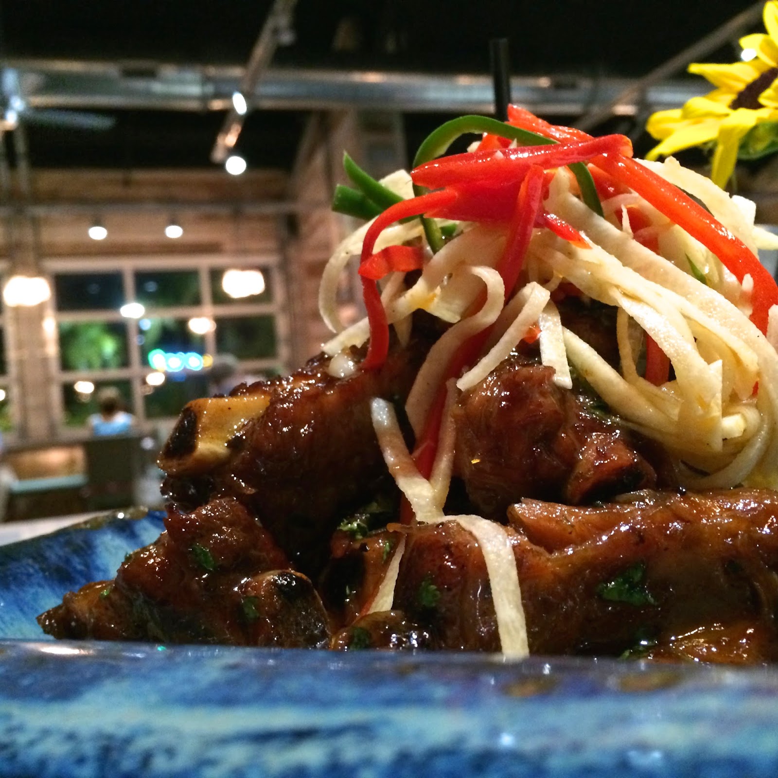 Braised Sticky Sweet Pork Ribs topped with Homemade Jicama Slaw served over Cheese Grits