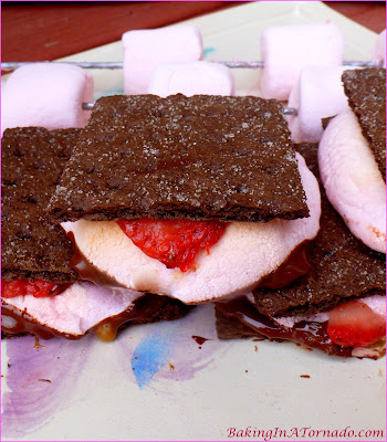 Chocolate, caramel and strawberry flavors marry to form a special treat: Supreme S’mores. Grill, microwave or bake for a year round quick dessert. | Recipe developed by www.BakingInATornado.com | #recipe #dessert #chocolate