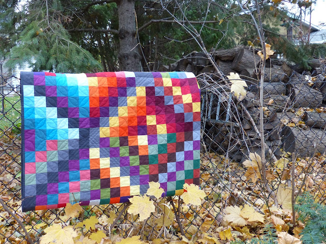 Folded Carsick quilt on fence