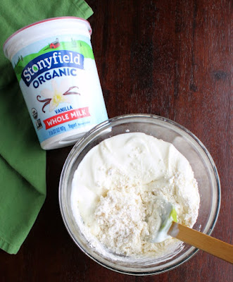 containter of stonyfield yogurt and bowl of yogurt drop biscuit dough