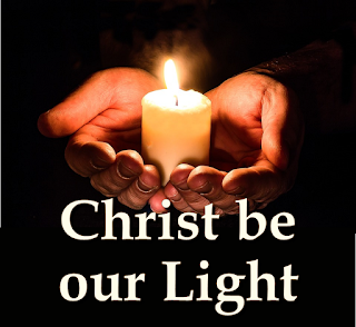 hands holdling a lighted candle - invoking Christ to be our light