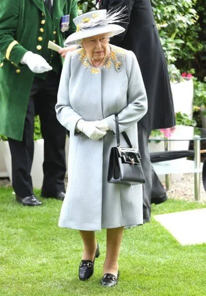 The Countess of Wessex wore a  wide-leg jumpsuit by Emilia Wickstead. Princess Eugenie wore a belted silk satin midi dress by Cefinn