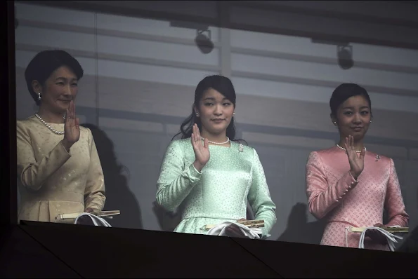 Members of the Imperial family wave to well-wishers during the celebration for the New Year on the veranda of the Imperial Palace