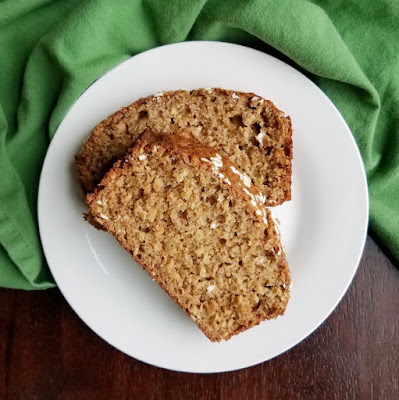 Applesauce oatmeal bread is a delicious sweet quick bread that's perfect for breakfast, tea time, snack or even a light dessert. The vanilla honey butter helps take to the next level of yumminess! slices of applesauce oatmeal quick bread on pate