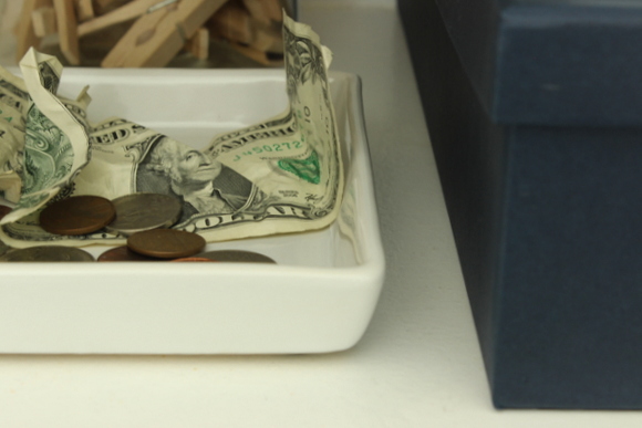 Use a tray in your organized laundry room cabinets to hold loose change